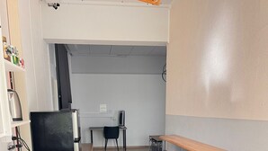 A modern kitchen with a granite countertop, a built-in oven, and a sink. There is a wooden dining table with four chairs. - Bright, comfy, industrial looking (Fällanden)