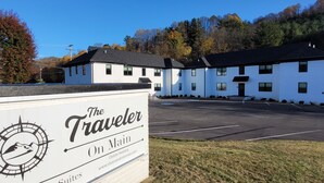A sign for The Traveler On Main, indicating it is a vacation suite hotel. - The Traveler on Main - Suite #4- Across the Street from Back of the Dragon! (Tazewell)