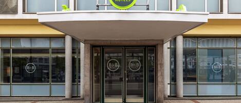 A B&B hotel entrance with a modern design, featuring large glass doors and a prominent B&B logo above the entrance.