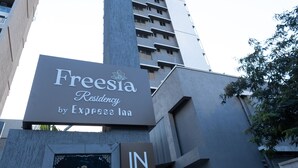 A tall building with a sign for Freesia Residency by Express Inn. - Freesia Residency By Express Inn - Navi Mumbai (Navi Mumbai)