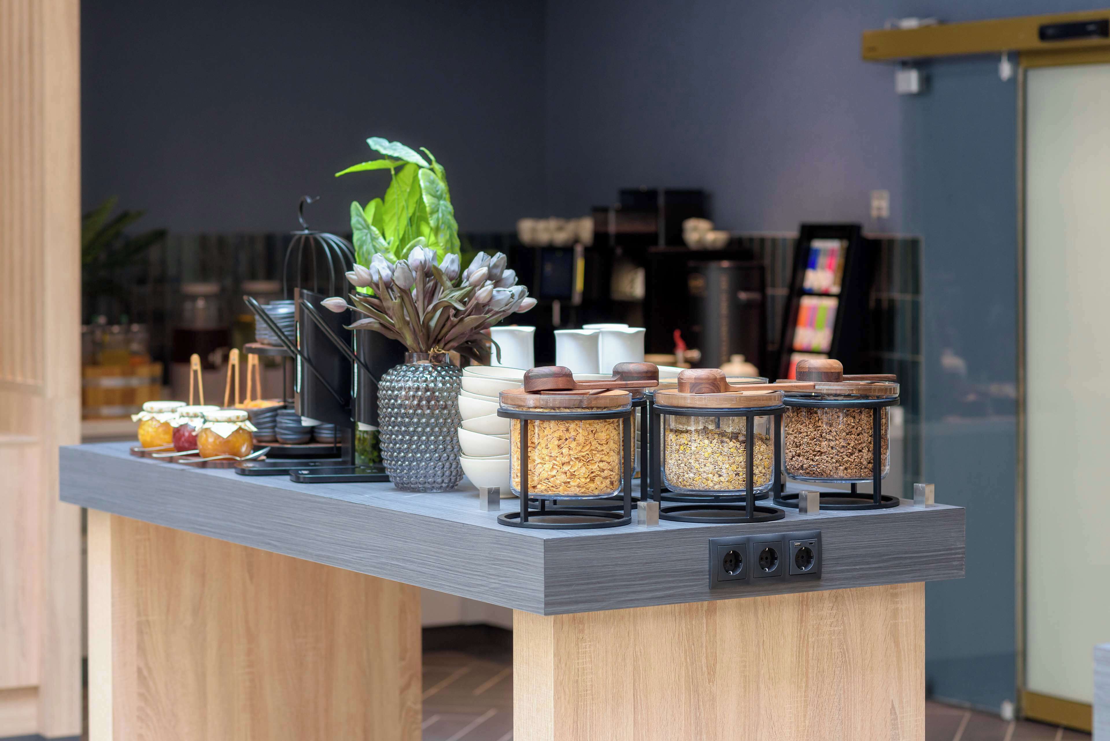 A breakfast bar with various food items and containers.