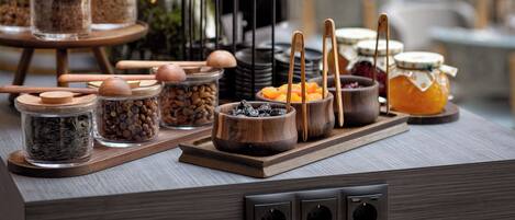 A buffet setup with various food items and utensils.