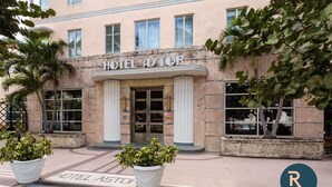 A hotel with a classic facade, large windows, and a prominent entrance. - Roami at Hotel Astor (Miami Beach)