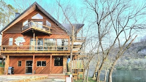 A wooden lodge with a balcony, a stone pathway, and a sign indicating private access. - White River Lodge #3 (Lakeview)