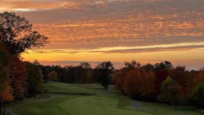 A golf course with a sunset view, surrounded by trees with autumn foliage. - Soft Landings at the Hangar House! Next to the Clubhouse and Airstrip (Danbury)