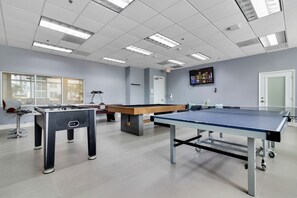 A room with a foosball table, a ping pong table, and a pool table. - Spacious 2 Bed Unit in Brickell with Free Parking (Miami)