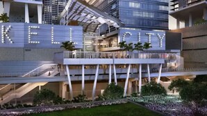 A modern hotel with a prominent 'KELL CITY' sign, multiple floors, and a rooftop garden. - Amazing 1 Bed in Brickell key W/ FREE PKG (Miami)