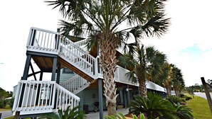A multi-level building with a white exterior and a staircase leading to the upper levels. - Bayview (Orange Beach)