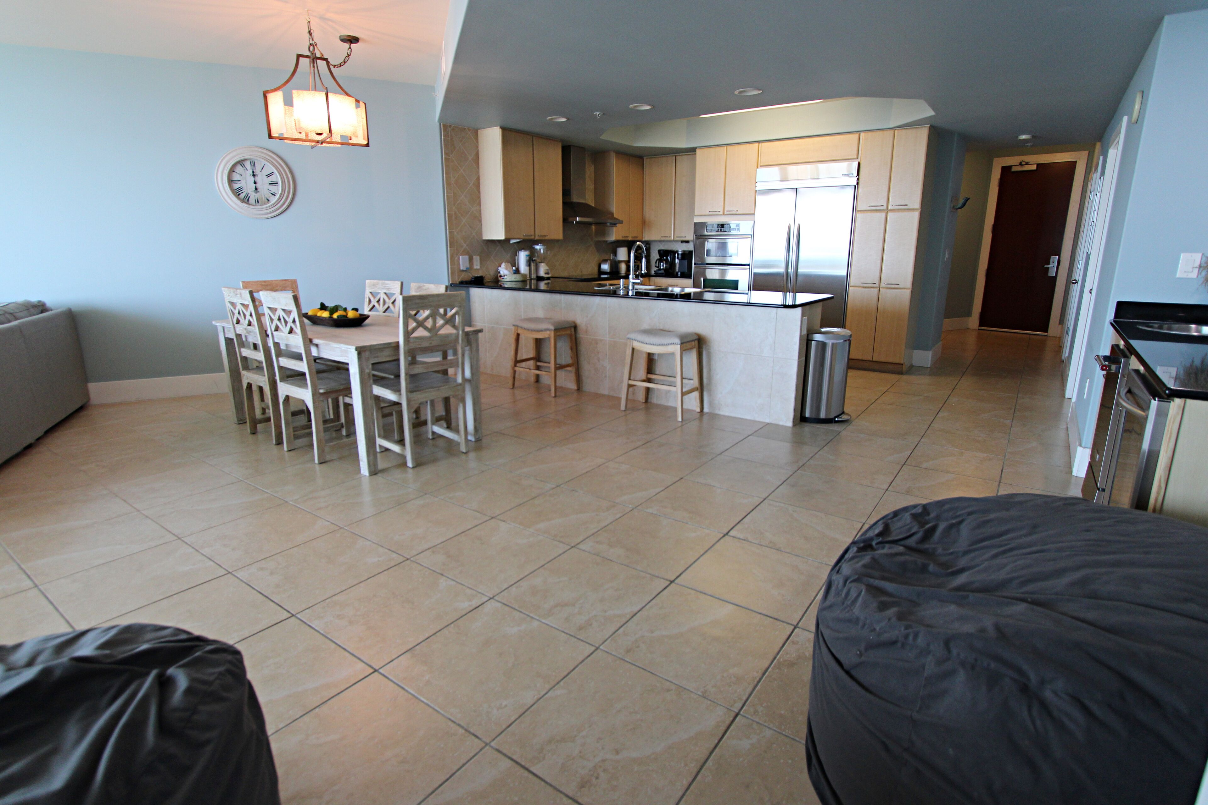 A modern kitchen with a dining area, a large island, and a separate dining table.