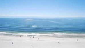 A beach with a clear sky and calm sea.
