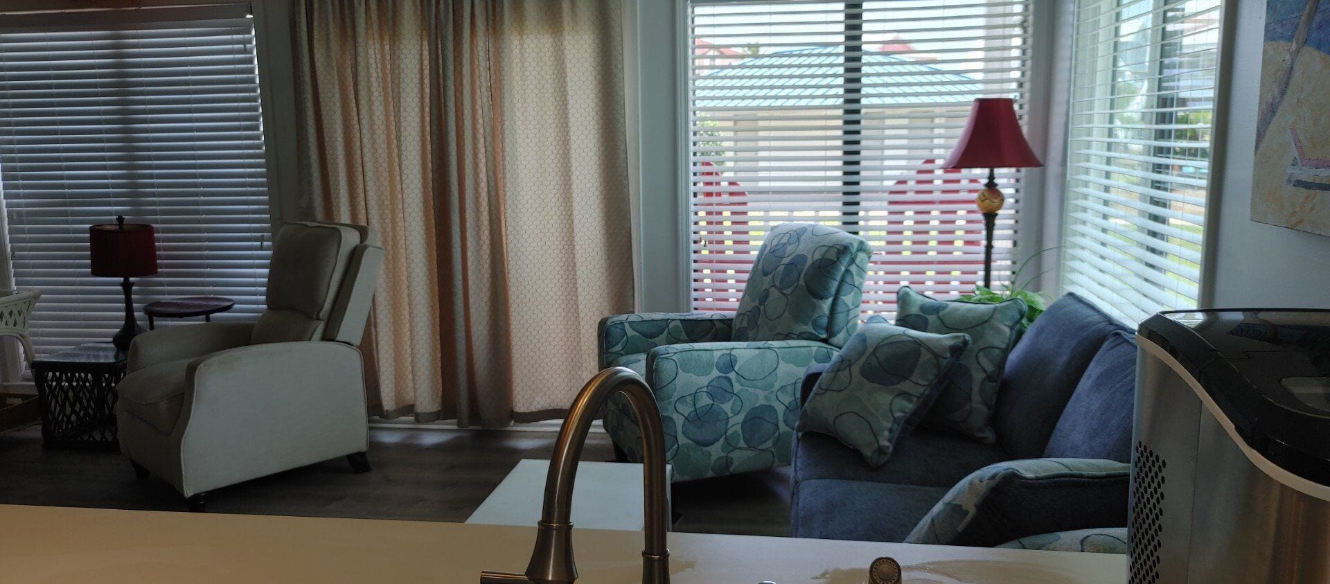 A living room with a sofa, armchair, and a small table.