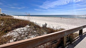 A beach with a wooden walkway and a clear view of the ocean. - Phoenix V (Orange Beach)