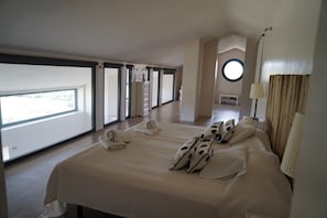 A spacious bedroom with a large bed, multiple windows, and a view of the outdoors. - Luxury Holiday Villa with private swimming pool amidst 300 olive trees (Ronda)