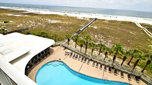 A resort with a swimming pool, beach access, and palm trees. - Tidewater (Orange Beach)