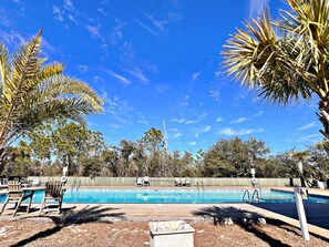 A swimming pool with lounge chairs and a wooden deck. - Southern Coastal (Orange Beach)