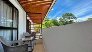 A balcony with a wooden pergola, two wicker chairs, and a table. - Villeta Resort Hotel (Villeta)