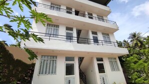 A multi-story building with balconies, large windows, and a staircase leading to the upper floors. - Marian Villa Katunayake  (Seeduwa - Katunayake)