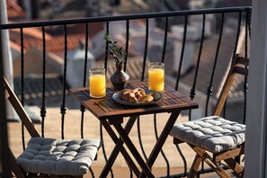 Relax in this charming outdoor seating area with a table, two chairs, and a beautiful view.