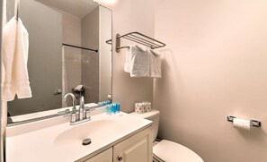A bathroom with a sink, mirror, towel rack, toilet, and toiletries. - Lux Designer Gulch Home - Skyline Views - 11 Beds! (Nashville)