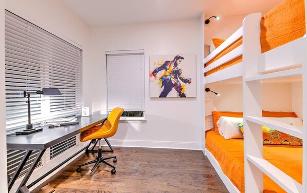 A bedroom with bunk beds, a desk, a chair, and a window with blinds. - Lux Designer Gulch Home - Skyline Views - 11 Beds! (Nashville)