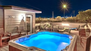 A hot tub on a wooden deck with chairs and a small building in the background. - Huge Lux Home Rooftop Views + Hot Tub, Pool+Sauna! (Nashville)
