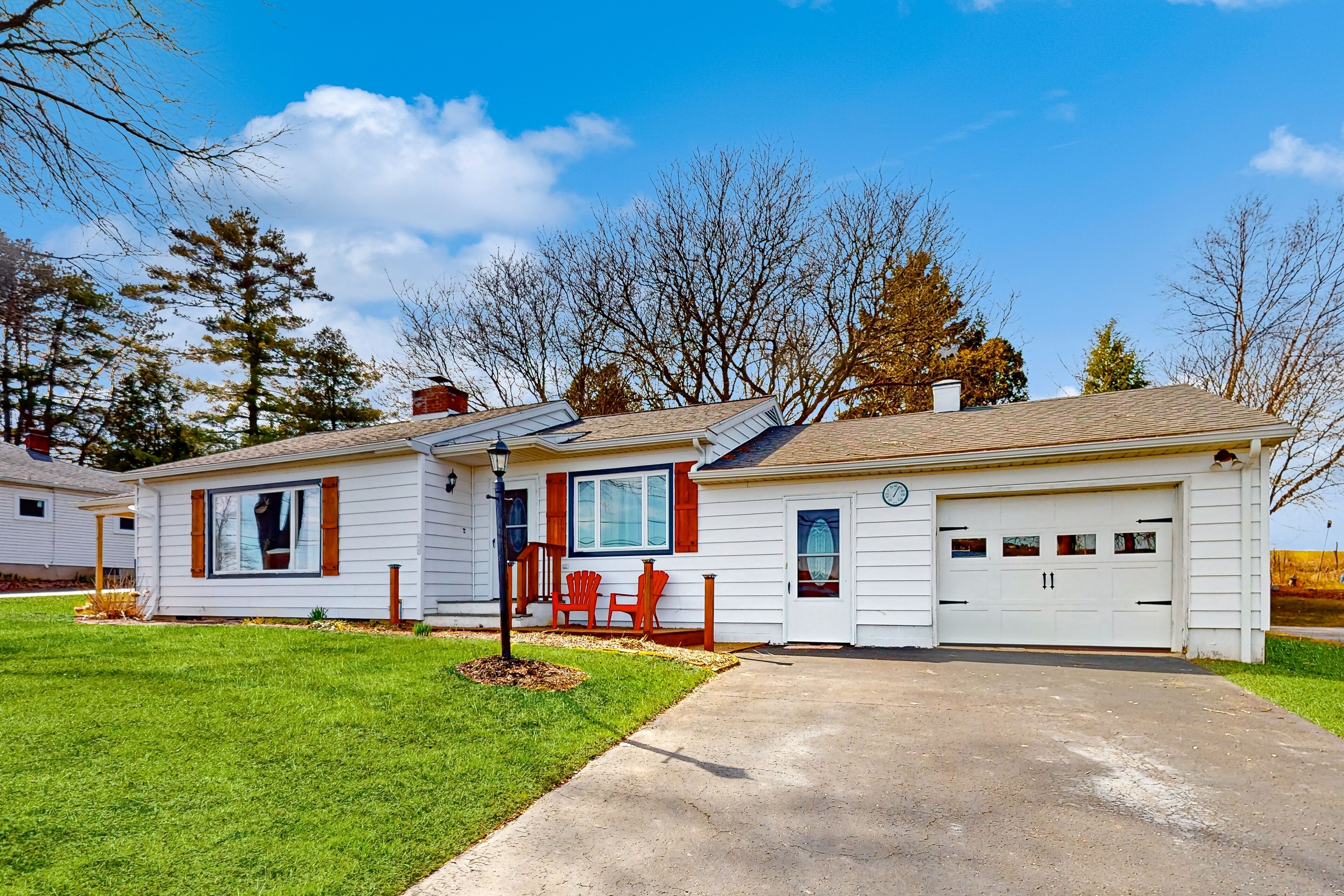 Waterfront home with stunning Owasco Lake view, dock, firepit & covered porch