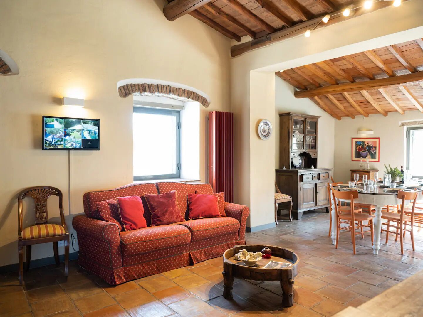Un salon confortable avec un canapé, une table basse et un téléviseur fixé au mur.