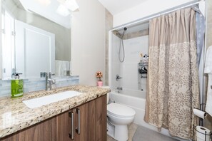 Shower, hair dryer, towels, soap - ModernComfort Home (Calgary)