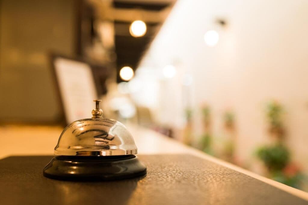 A hotel reception area with a clear view of a reception desk and a blurred background suggesting a spacious interior.