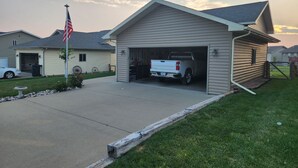 A single-story house with a garage, a driveway, and a lawn. - South Dakota Black Hills rental (Whitewood,)