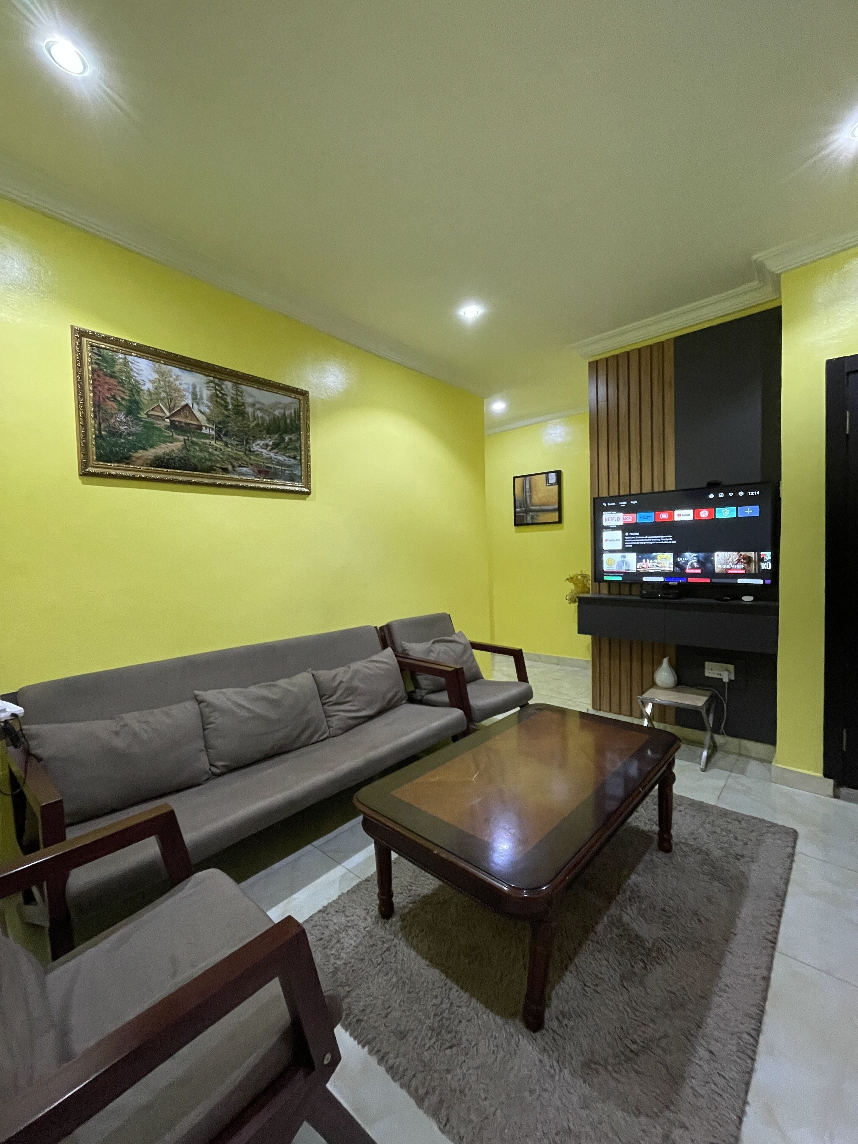 A living room with a sofa, coffee table, and TV.