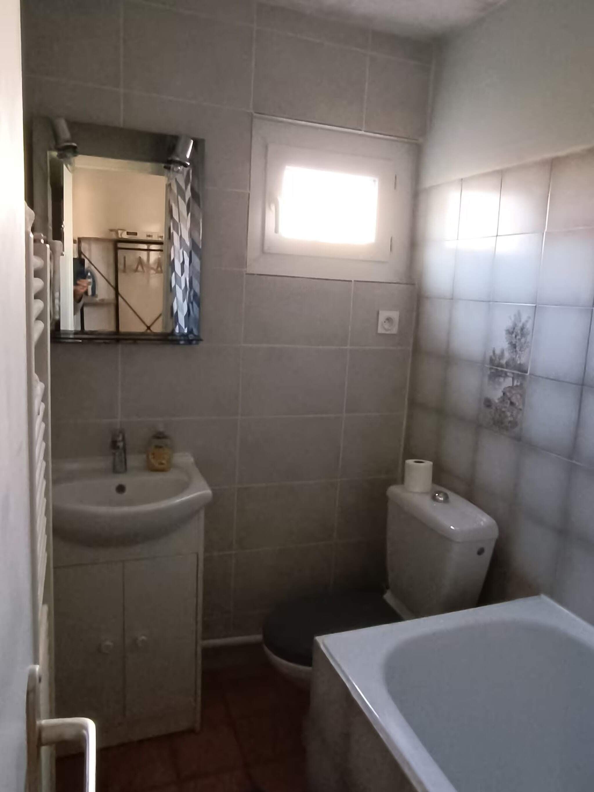 Un baño con lavamanos, inodoro y bañera.