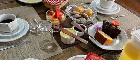 A table set with various breakfast items including pastries, fruits, and beverages.
