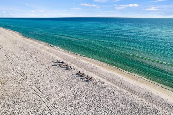 A beach with clear turquoise water and a sandy shore.