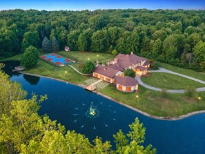 A large house with a swimming pool, tennis court, and a dock. - 12,000 Sq Ft Luxury Mansion | Events & Weddings (Medina)