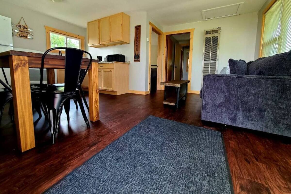 A compact living space with a dining area, kitchenette, and a sofa.