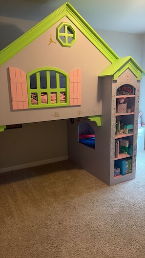 A children's playhouse with a green roof, pink shutters, and a small window. - Minutes to Six Flags, Walmart, and the #1 restaurant in town with gated fence!! (Douglasville)