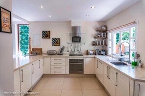 Modern kitchen with oven, microwave, and double sink.