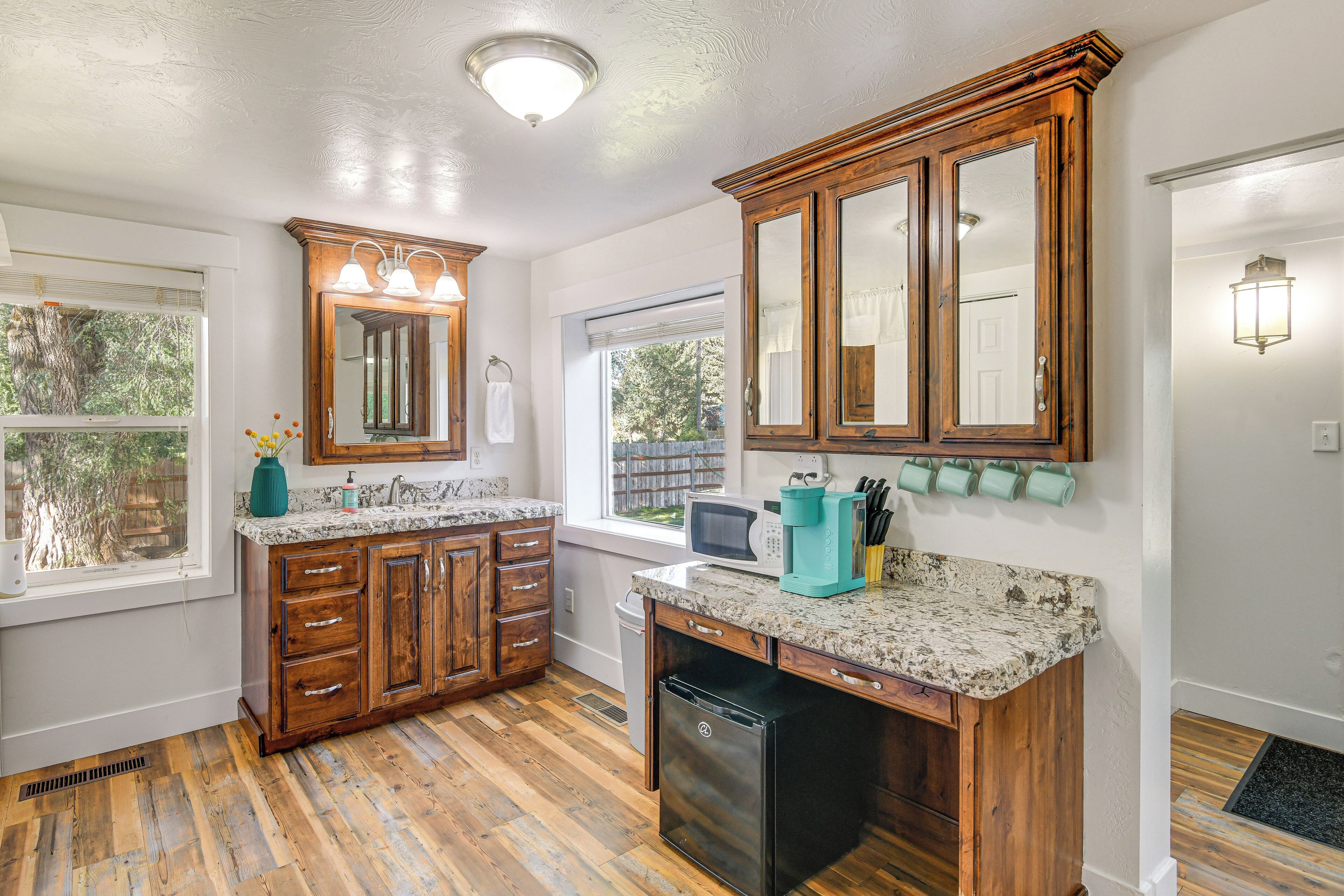 A kitchen with wooden cabinets, a built-in microwave, and a dishwasher.