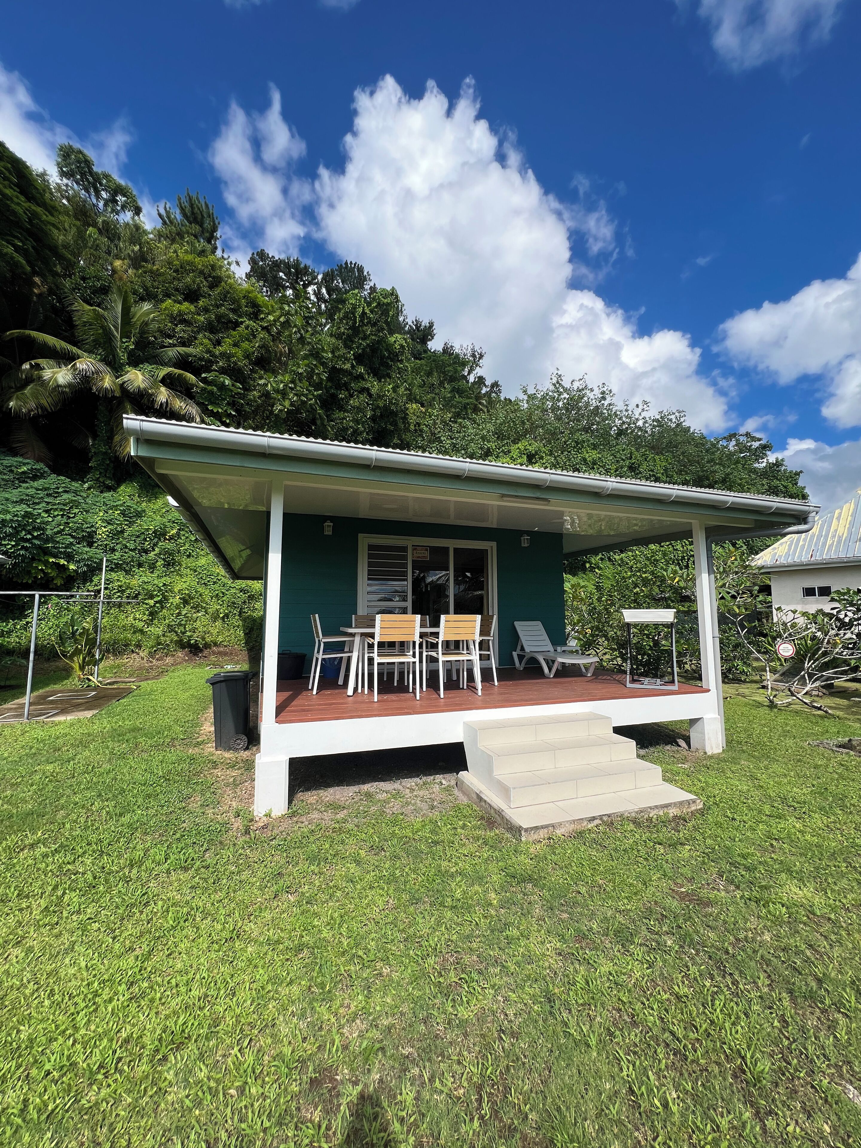 A small, single-story building with a covered patio area.