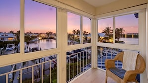 A balcony with a view of a marina and sunset. - Siesta Bayside With Bay/dock Views (Siesta Key)