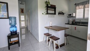 A kitchen with a water dispenser, a microwave, and a sink. - Elle's 2 BR/2 bathroom, home in San Ignacio. Minutes from town & Maya Ruins (Cayo District)