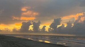 A beach with a sunset and clouds. - Gated 5 Bed • 4 Bath • Private Beach Access • Early Check-In & Late Checkout (Bolivar Peninsula)