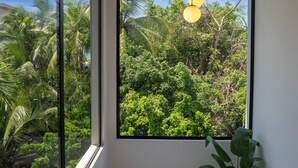 A room with large windows, a wooden ceiling, and a hanging light fixture. - Brand New Luxury Villa on the South End of Jaco Beach, Steps from the Beach! (Jaco)