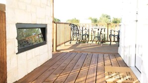 A wooden deck with a metal railing, a window, and a door. - Rustic Tiny Home Escape - Pets Stay Free! (Georgetown)