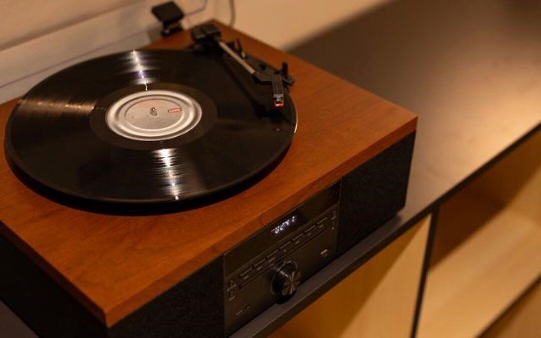 A turntable on a wooden cabinet with a control panel.