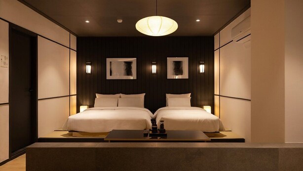 A modern hotel room with two beds, a central light fixture, and wall-mounted sconces. - Mitasuya Ryokan Hotel Incheon by Anook (Incheon)