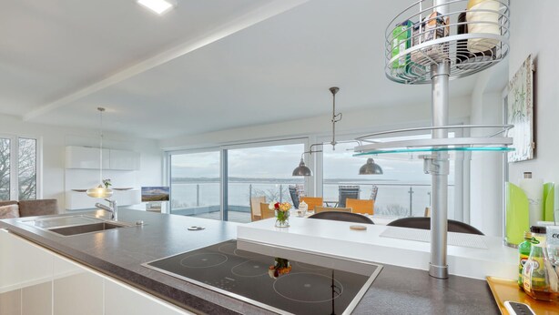 A modern kitchen with a large island, a built-in oven, and a view of the city. - 2 bedroom nice apartment in Eckernförde (Eckernförde)
