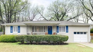 A single-story house with a front porch, a garage, and a well-maintained lawn.