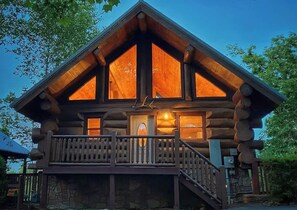 A log cabin with a balcony and a staircase leading to the entrance. - Roomy, Clean Mountain Retreat - Amazing Views! - Highly Rated - REAL Log Cabin! (Gatlinburg)